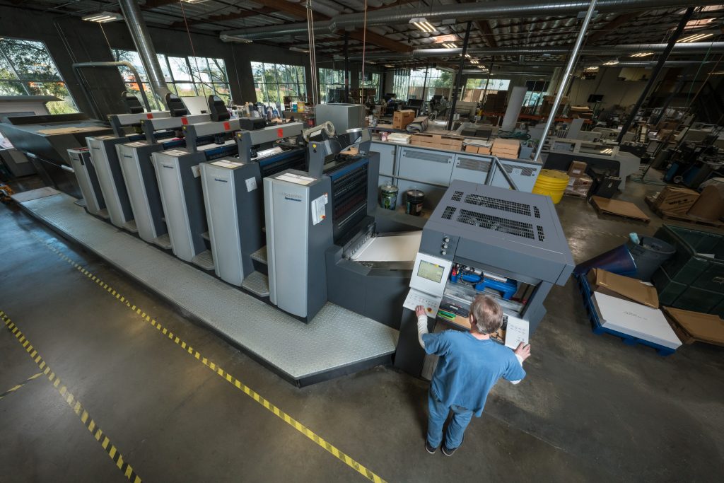 Wide view of a multi-unit offset press for high-volume runs, a key factor in digital vs offset printing decisions.