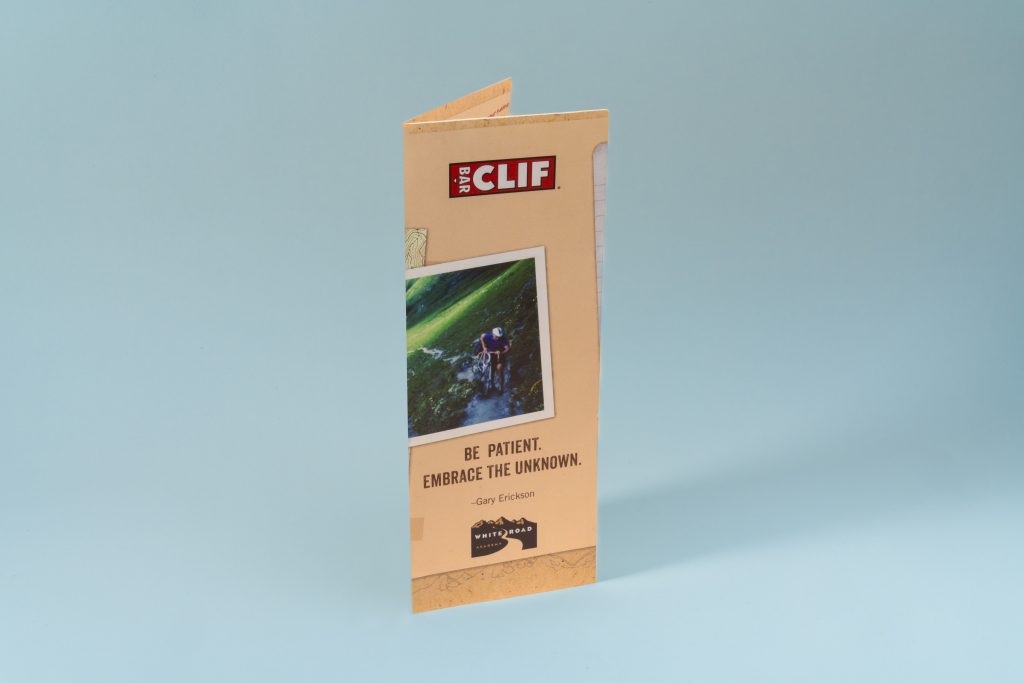Tri-fold brochure printing example for Clif Bar, front panel with photo, quote, and logo on beige stock.