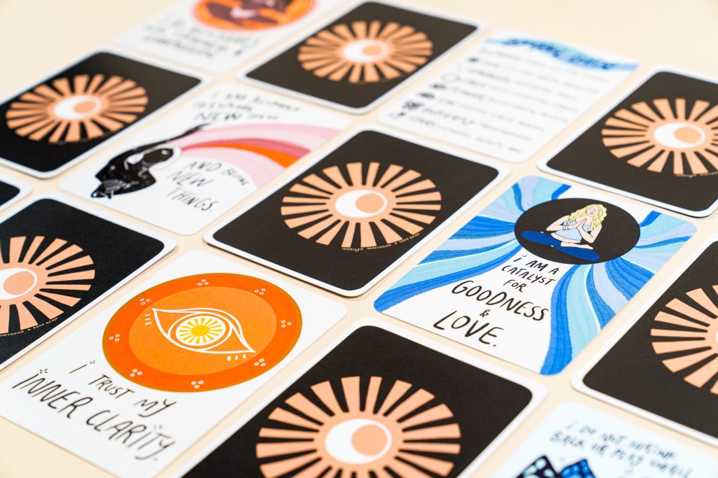 Customized playing card deck with illustrated affirmation cards and branded backs; print custom deck of cards with Greener Printer.
