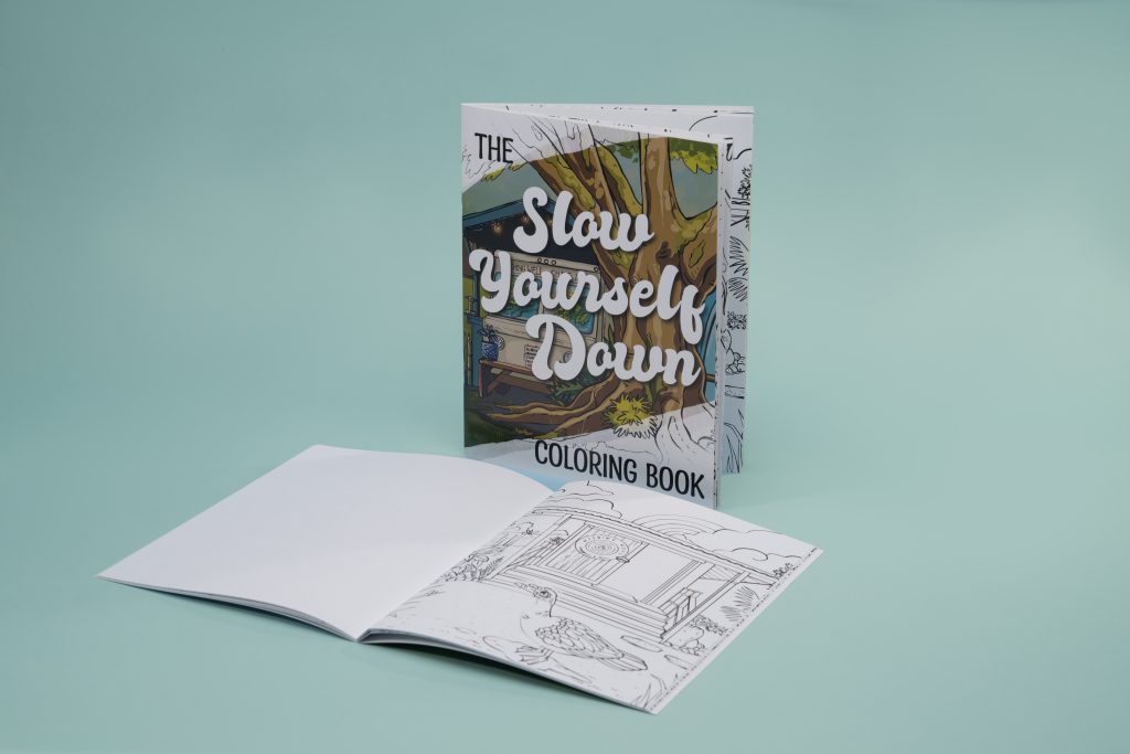 Open saddle stitch book showing black-line spread from custom coloring books; branded footer visible - ideal for personalized coloring books.