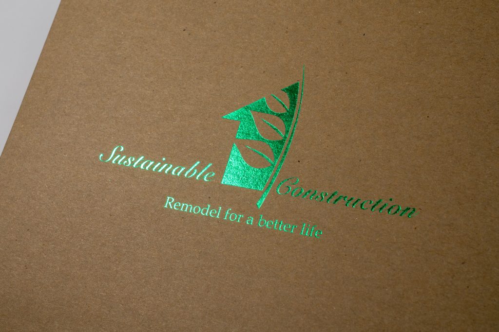 Green foil stamped logo on kraft paper folder with specialty finish on recycled stock for sustainable branded printing