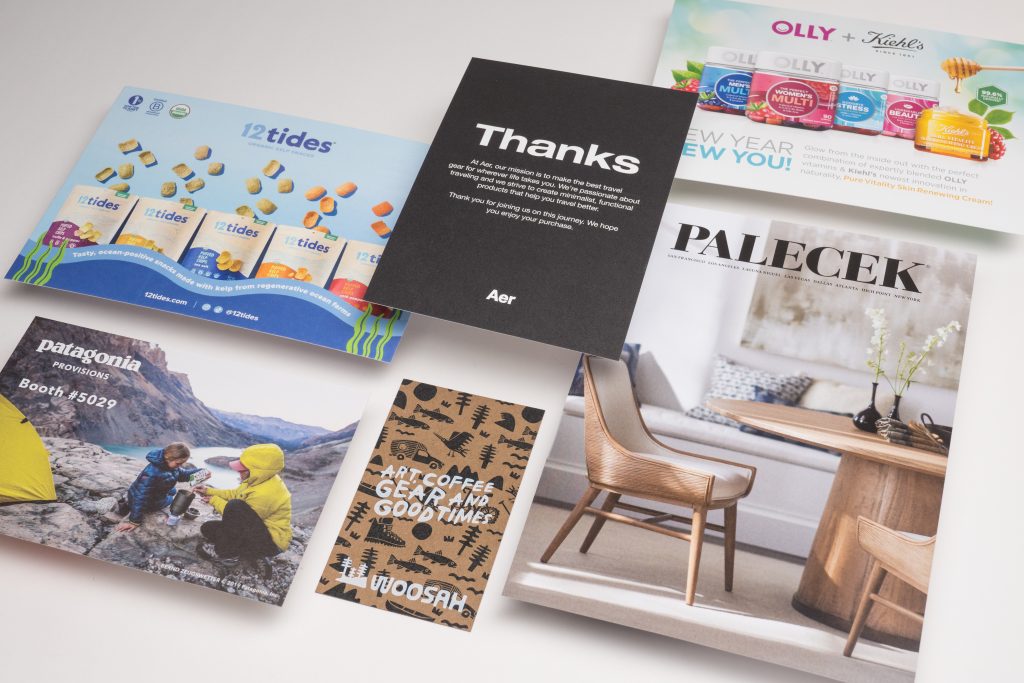 Assorted marketing print materials on matte and glossy paper.