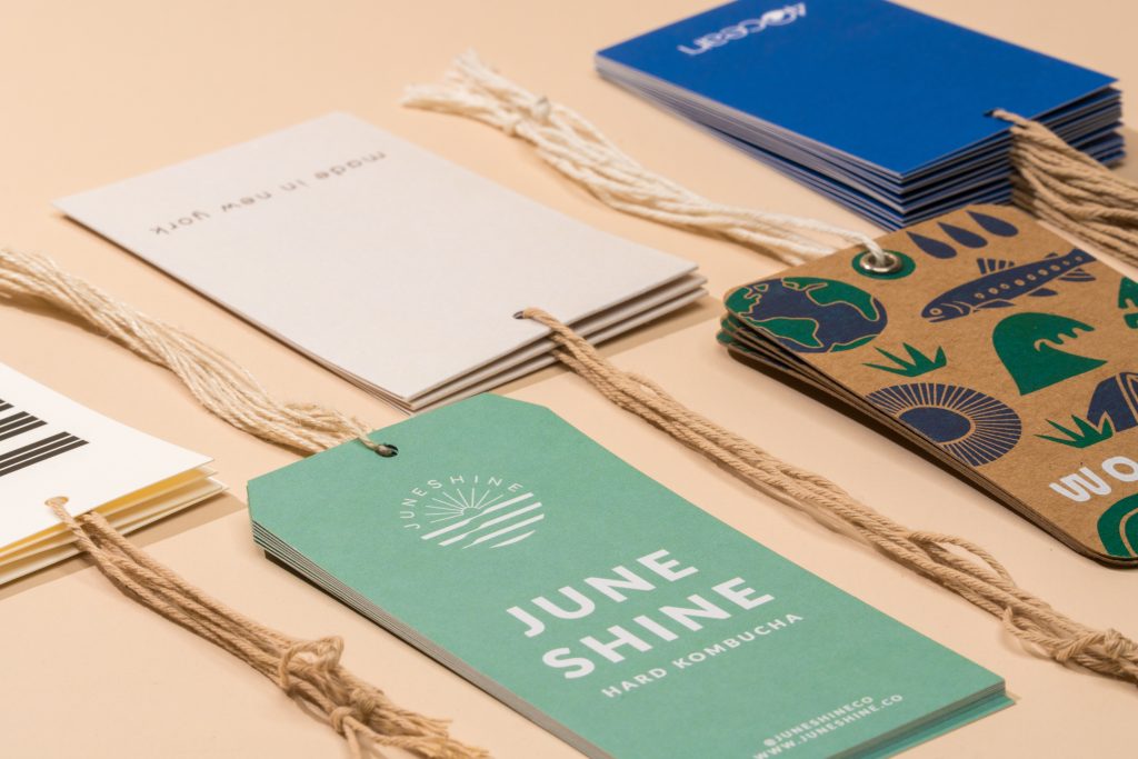 Die-cut hang tags and retail labels with twine string, printed on matte stock