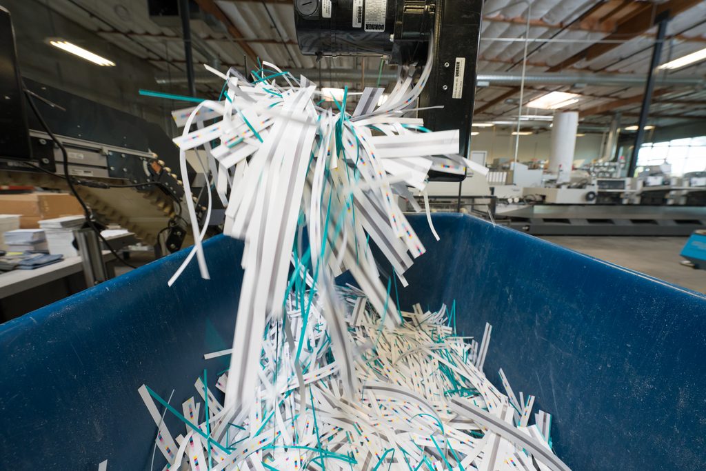 Recycling bin filled with used paper and cardboard destined for post-consumer recycling