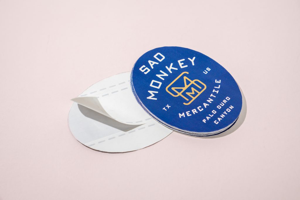 adhesive sticker in close up with the front and back design shown