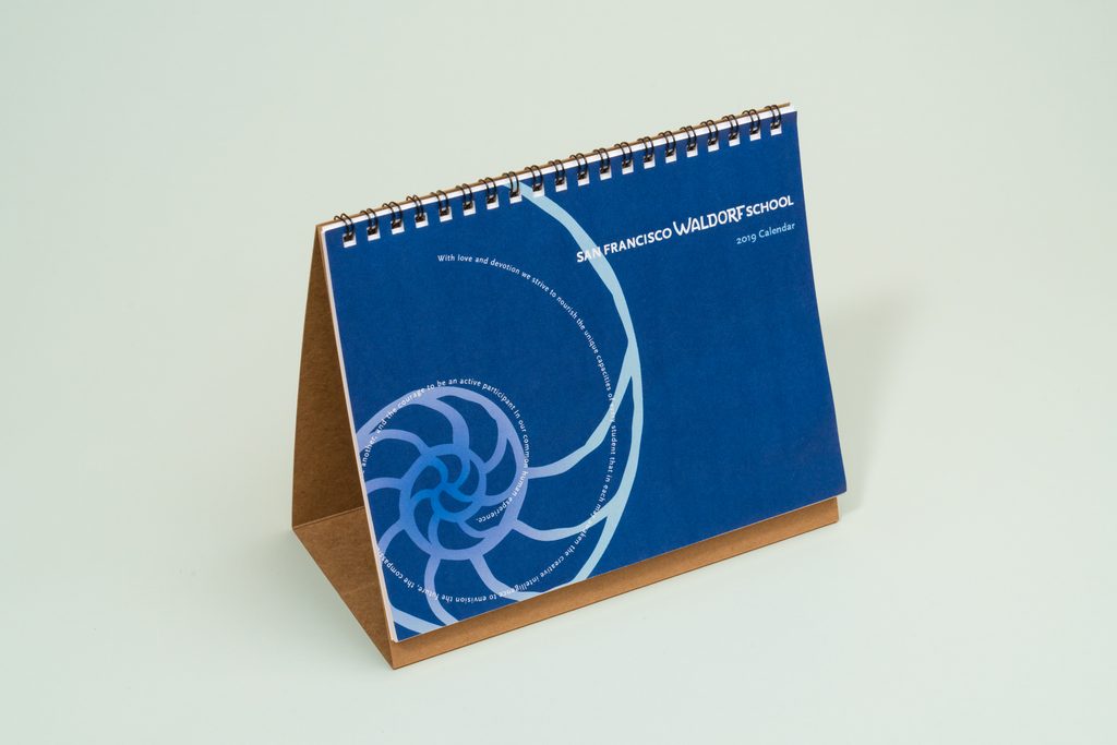 Custom branded desk calendar displayed on an office desk